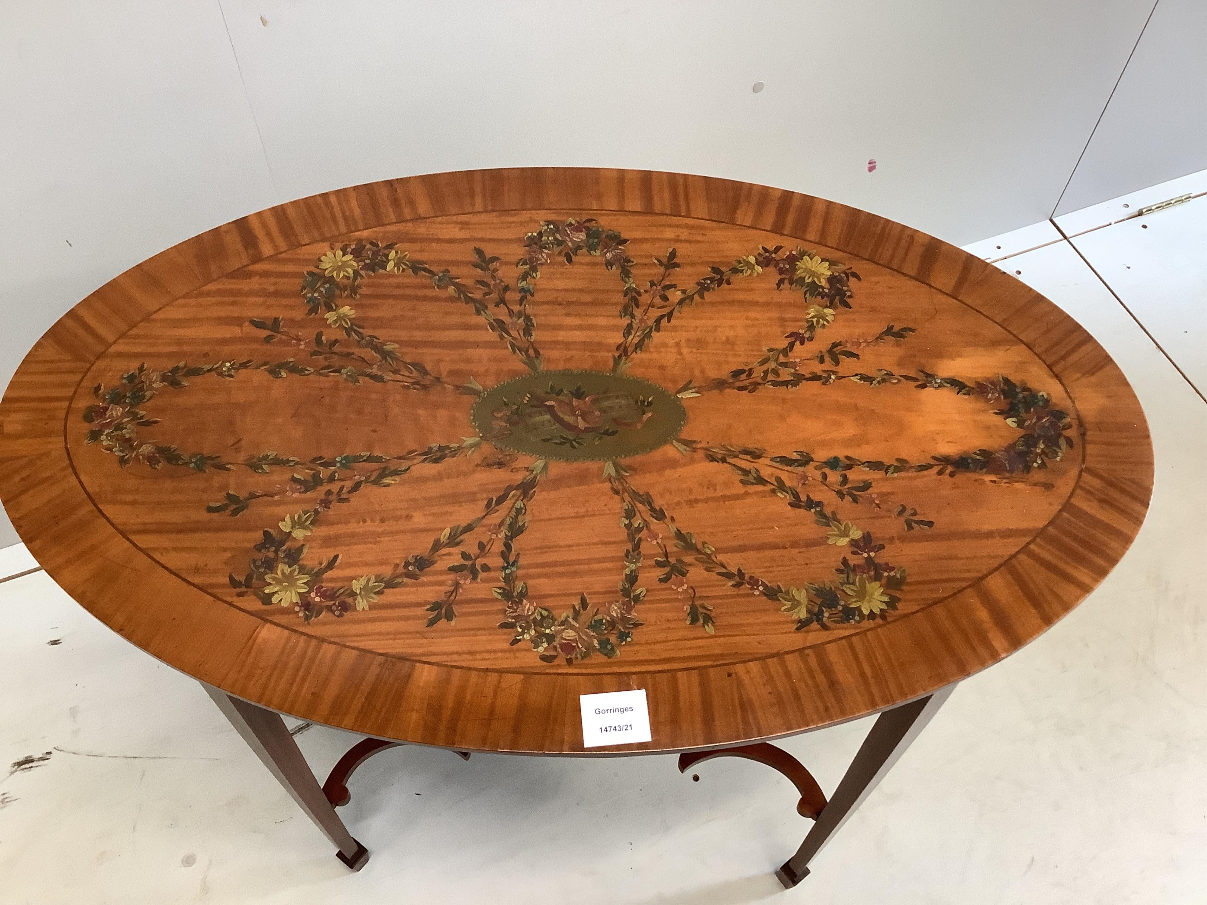 An Edwardian Sheraton Revival oval painted satinwood occasional table, width 81cm, depth 49cm, height 70cm. Condition - fair